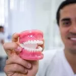 dentist holding dentures